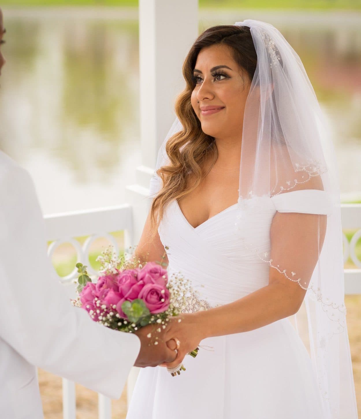 A bride holding a bouquet at the gazebo