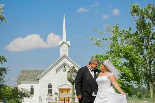 A couple outside the historic Heritage Park chapel