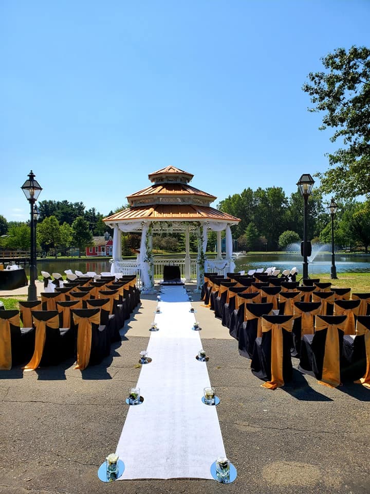 The lakeside gazebo prepared for an outdoor wedding ceremony